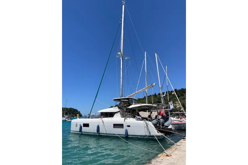 Eadan Doire Yacht Photos Pics 2017 Lagoon 42 catamaran docked at a marina under clear blue skies.