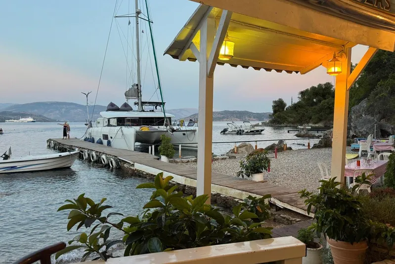 Eadan Doire Yacht Photos Pics Coastal view with 2017 Lagoon 42 catamaran docked at a serene seaside pier.
