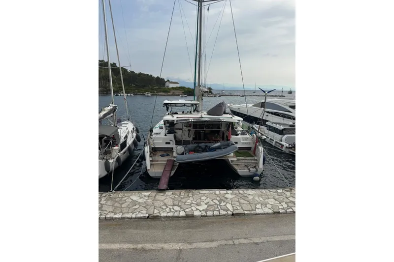 Eadan Doire Yacht Photos Pics 2017 Lagoon 42 catamaran docked at a marina, surrounded by other boats.