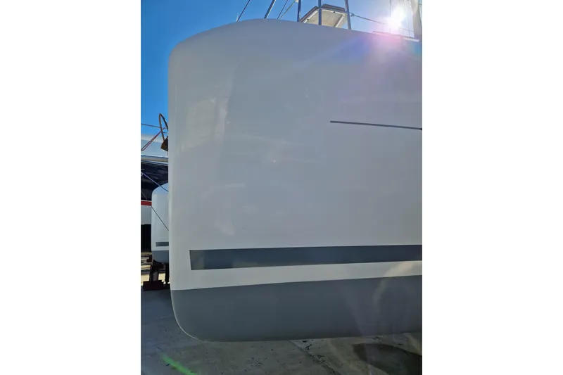Eadan Doire Yacht Photos Pics Side view of a 2017 Lagoon 42 catamaran hull under bright sunlight.