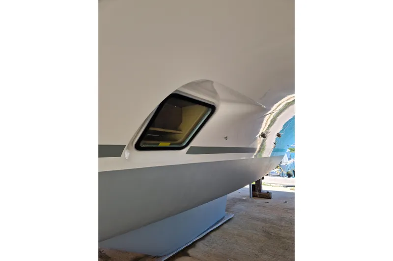 Eadan Doire Yacht Photos Pics Side view of a 2017 Lagoon 42 catamaran, showcasing sleek hull design and window.
