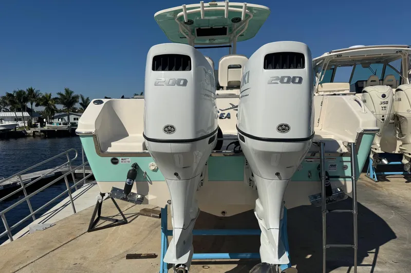  Yacht Photos Pics 2023 Sea Chaser 27 HFC CC boat with twin 200 horsepower engines docked by the water.