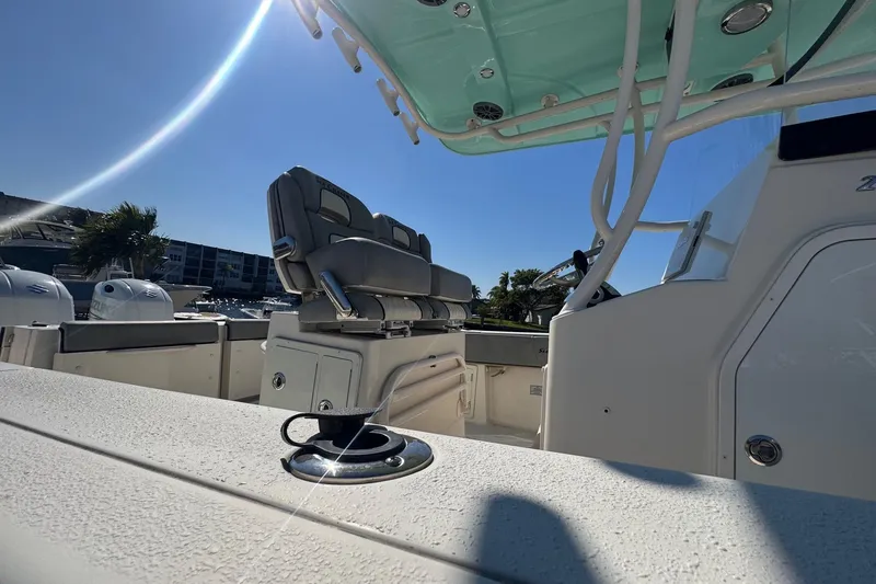  Yacht Photos Pics 2023 Sea Chaser 27 HFC CC boat interior with seating and console under clear blue sky.