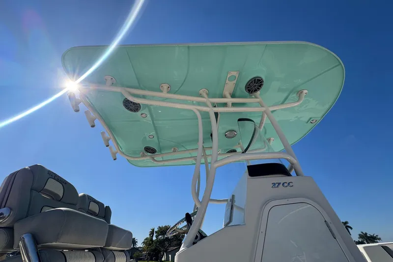  Yacht Photos Pics 2023 Sea Chaser 27 HFC CC boat with sunlit T-top against clear blue sky.