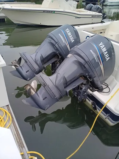 Gracie Yacht Photos Pics Twin Yamaha outboard motors on a 2009 Pursuit 310 OS boat, docked in a marina.