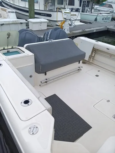 Gracie Yacht Photos Pics 2009 Pursuit 310 OS boat deck with covered seating and Yamaha engines at dock.