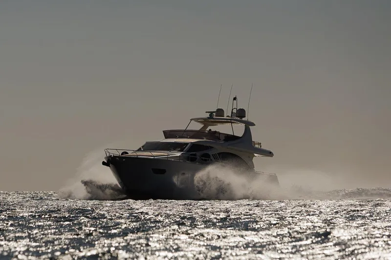 M/y Em-es II Yacht Photos Pics 2013 Ferretti Yachts 750 HT cruising on open water at sunset.