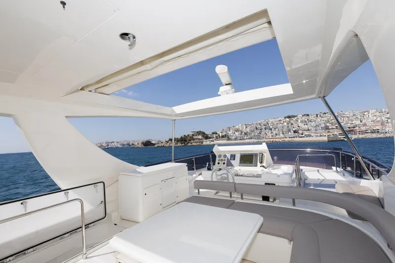 M/y Em-es II Yacht Photos Pics Luxurious 2013 Ferretti Yachts 750 HT with open deck and scenic coastal view.