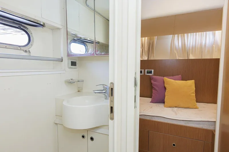 M/y Em-es II Yacht Photos Pics Interior of 2013 Ferretti Yachts 750 HT, featuring a cozy cabin and compact bathroom.