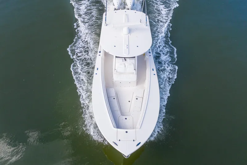  Yacht Photos Pics Aerial view of 2021 Regulator 31 boat cruising on water.