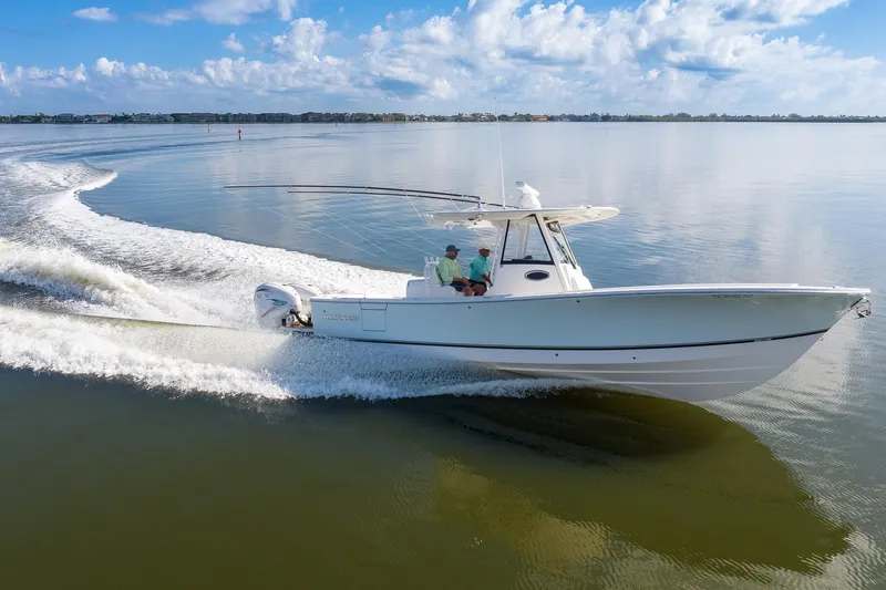  Yacht Photos Pics 2021 Regulator 31 boat cruising on calm water under a clear blue sky.