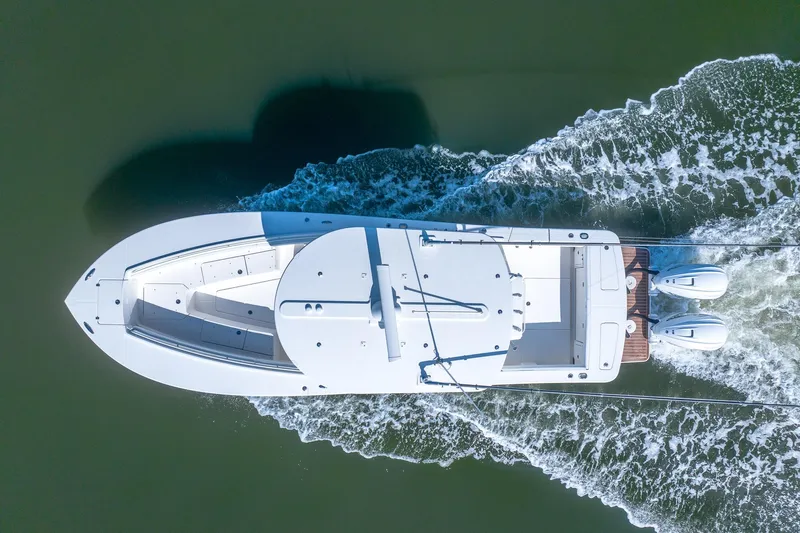  Yacht Photos Pics Aerial view of 2021 Regulator 31 boat cruising on water.