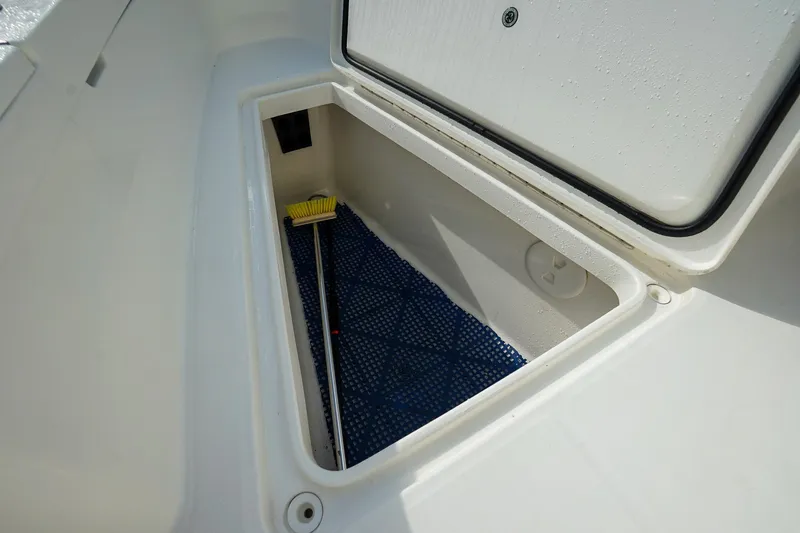 Yacht Photos Pics Storage compartment on 2021 Regulator 31 boat with cleaning brush inside.