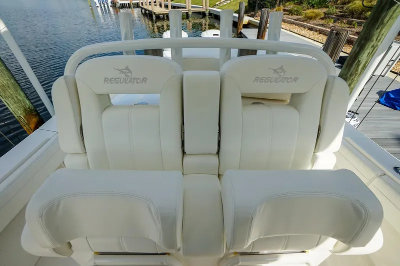  Yacht Photos Pics 2021 Regulator 31 boat seating with white upholstery at a dockside location.