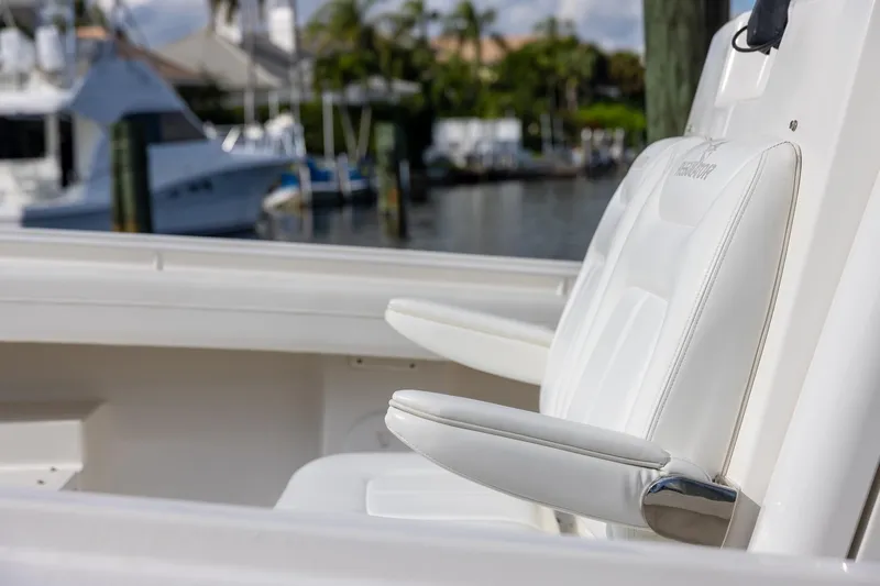  Yacht Photos Pics 2021 Regulator 31 boat with white seating, docked at a marina.