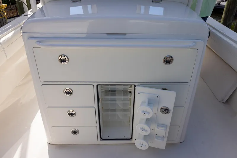  Yacht Photos Pics 2021 Regulator 31 boat storage compartment with open door and drawers.