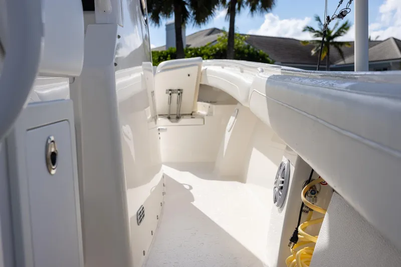  Yacht Photos Pics 2021 Regulator 31 boat interior with white seating and storage compartments.