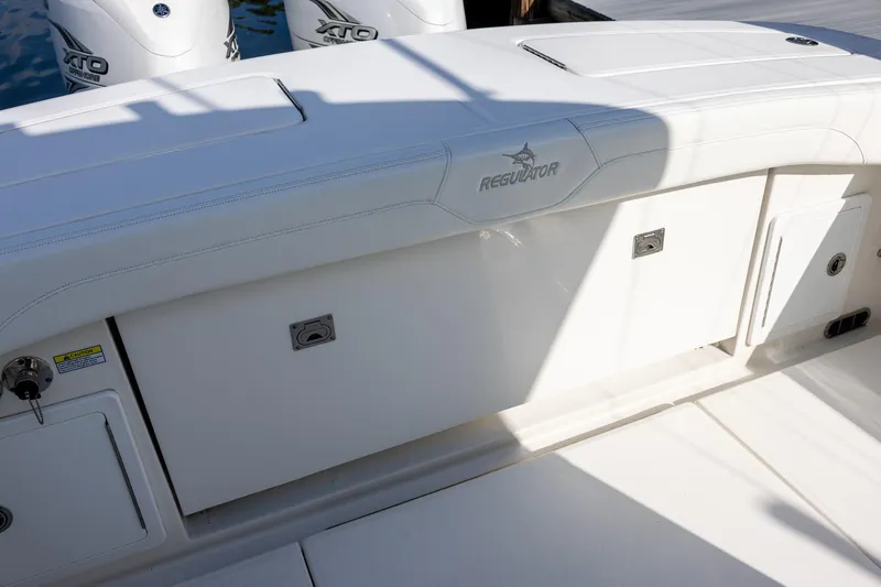  Yacht Photos Pics 2021 Regulator 31 boat with white seating and storage compartments.