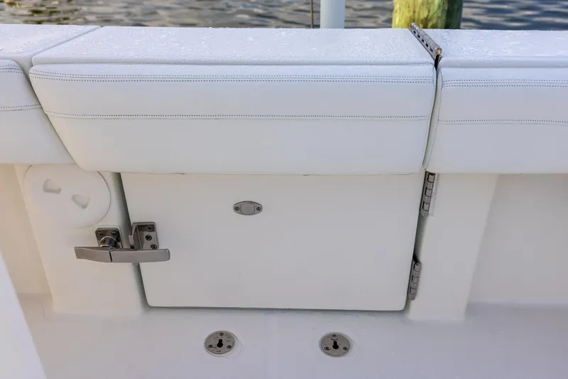  Yacht Photos Pics 2021 Regulator 31 boat with white cushioned seating and storage compartment.