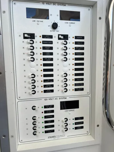 Lady Grace Yacht Photos Pics Electrical control panel on a 2022 Wesmac 38 boat, featuring 12V DC and 120V AC systems.
