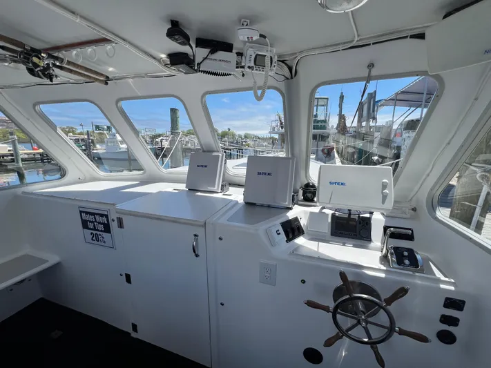 Lady Grace Yacht Photos Pics Interior of 2022 Wesmac 38 boat with navigation equipment and steering wheel.