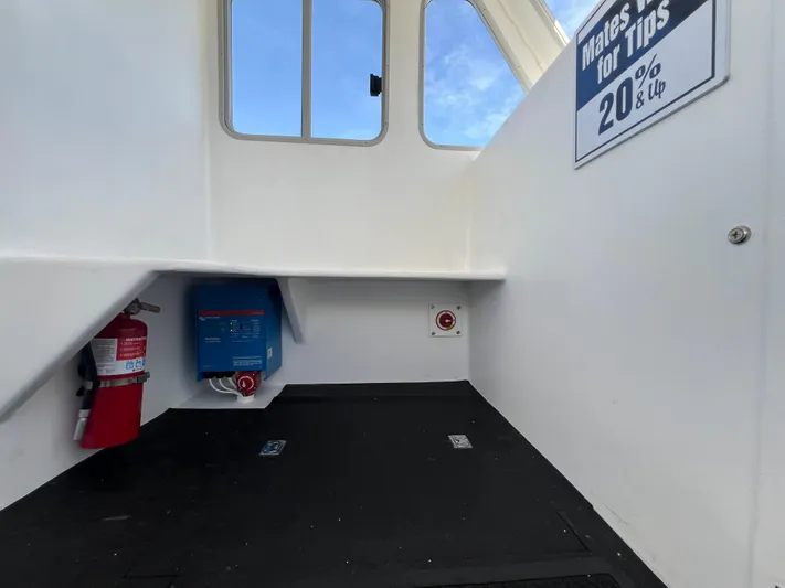 Lady Grace Yacht Photos Pics Interior of 2022 Wesmac 38 boat with fire extinguisher and tip sign.