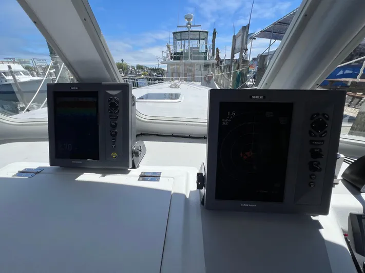 Lady Grace Yacht Photos Pics Helm of 2022 Wesmac 38 boat with navigation screens and marina view.