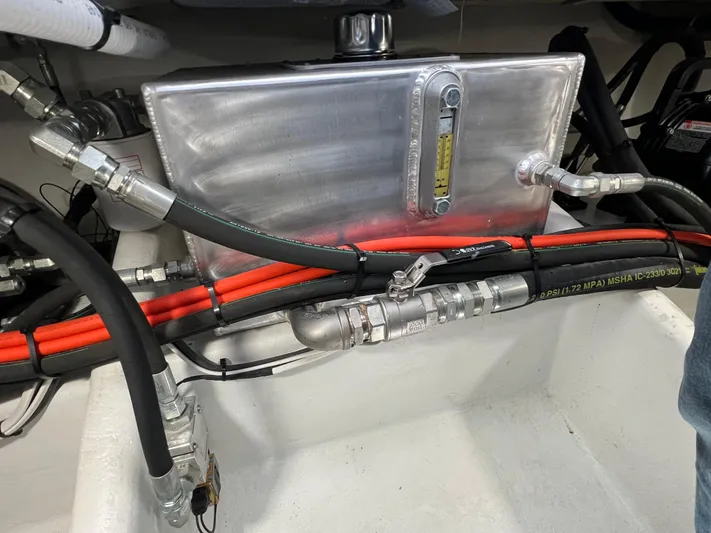 Lady Grace Yacht Photos Pics Engine compartment of a 2022 Wesmac 38 with hydraulic hoses and metal tank.