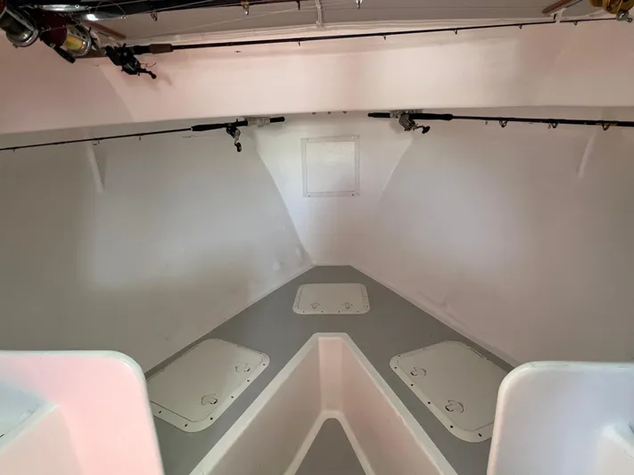 Lady Grace Yacht Photos Pics Interior of 2022 Wesmac 38 boat, featuring storage compartments and fishing rod holders.