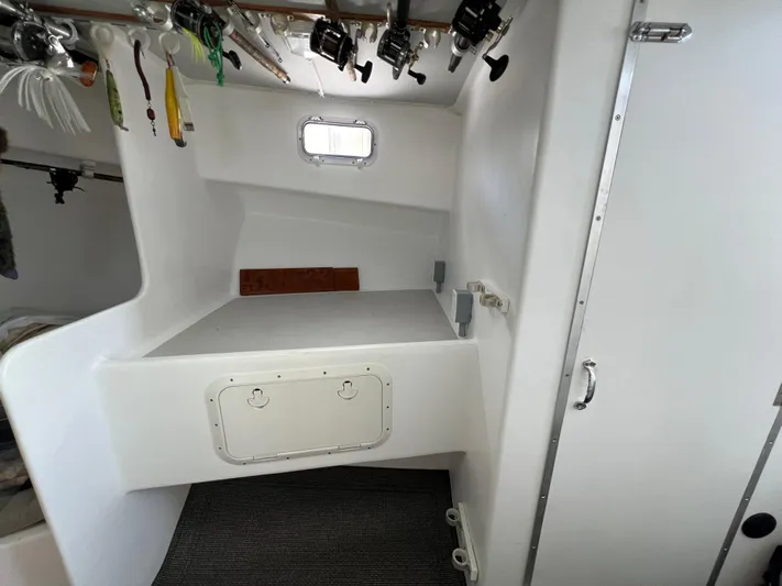Lady Grace Yacht Photos Pics Interior of 2022 Wesmac 38 boat with fishing rods and storage area.
