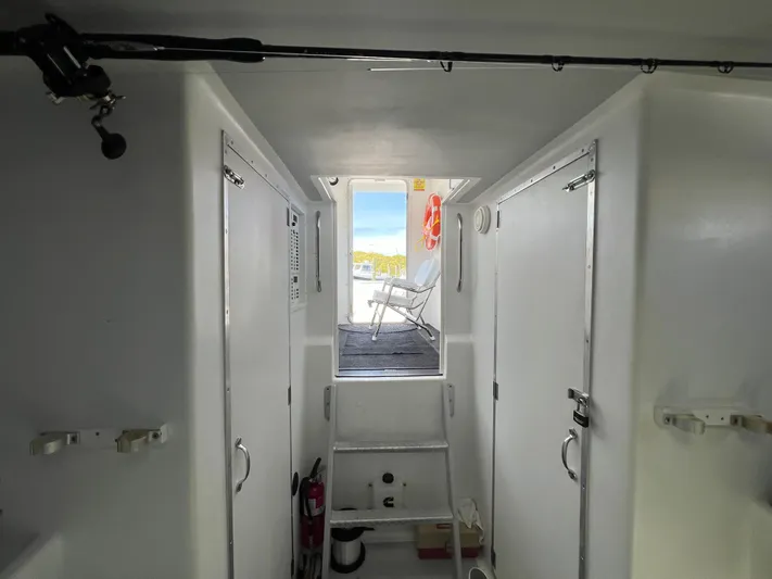 Lady Grace Yacht Photos Pics Interior view of 2022 Wesmac 38 boat, featuring white cabin and outdoor seating.