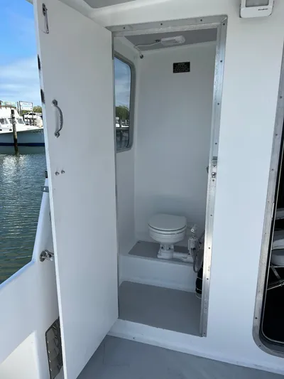 Lady Grace Yacht Photos Pics 2022 Wesmac 38 boat interior with compact bathroom and toilet.