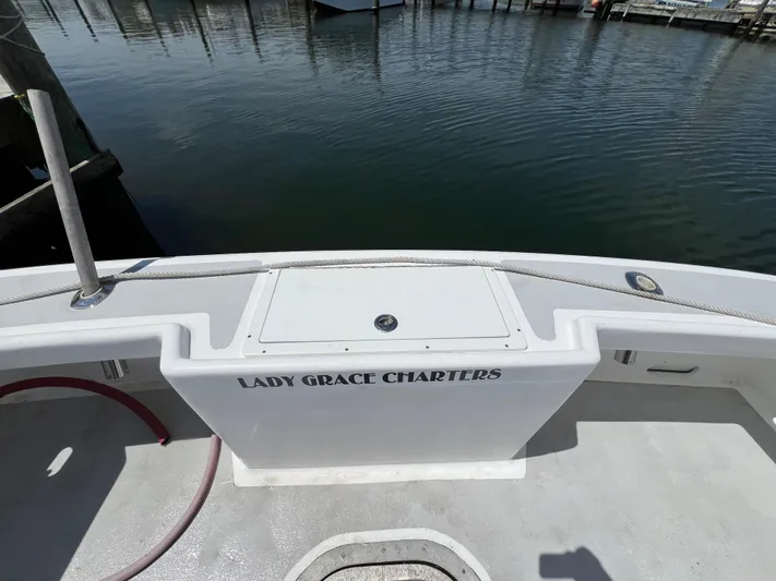 Lady Grace Yacht Photos Pics Wesmac 38 boat, 2022 model, docked with "Lady Grace Charters" signage on deck.