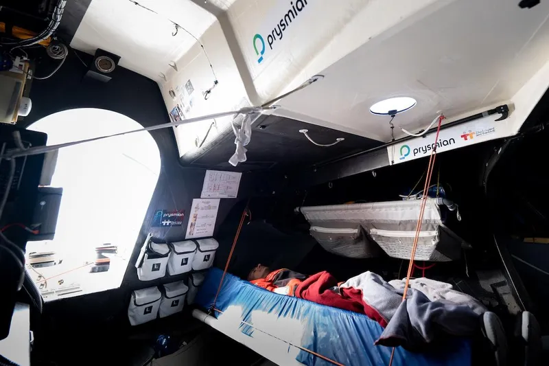 Prysmian Yacht Photos Pics Interior of 2015 Multiplast Imoca 60 yacht, featuring sleeping area and storage compartments.