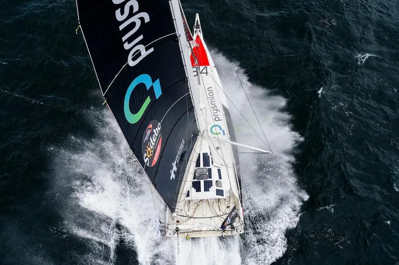 Prysmian Yacht Photos Pics Sailing yacht Imoca 60 by Multiplast, 2015, cutting through ocean waves.