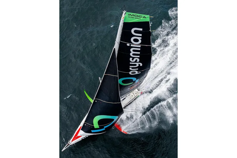 Prysmian Yacht Photos Pics Aerial view of 2015 Multiplast Imoca 60 sailboat racing on the ocean.