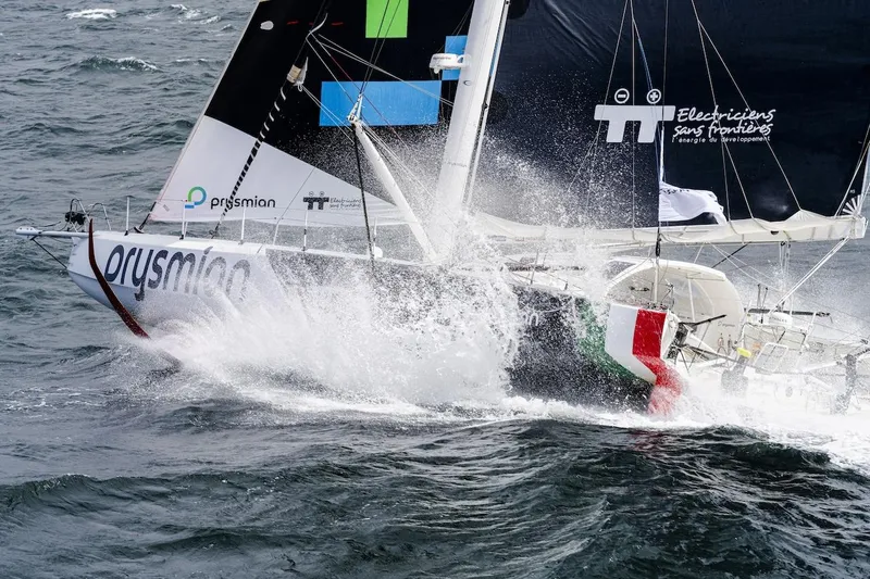 Prysmian Yacht Photos Pics Sailing yacht Imoca 60 by Multiplast, 2015, cutting through ocean waves.