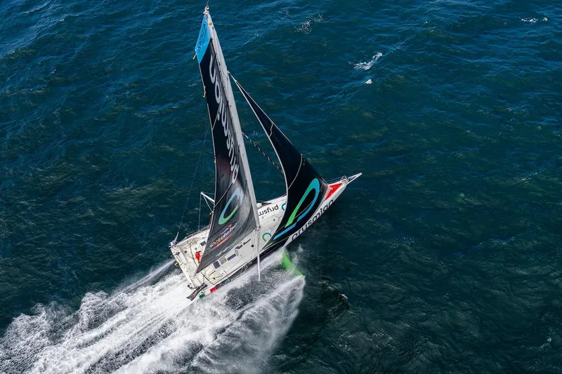 Prysmian Yacht Photos Pics Aerial view of 2015 Multiplast Imoca 60 sailboat racing on open ocean.