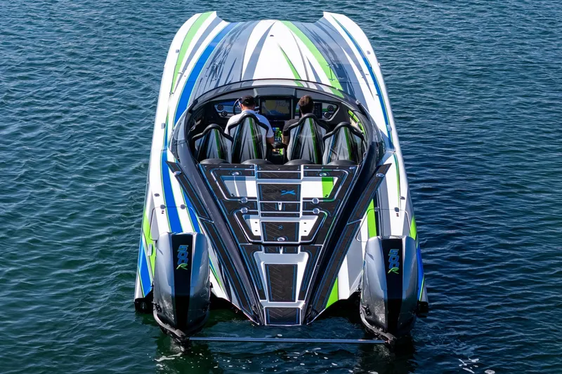  Yacht Photos Pics 2022 MTI 390X powerboat with vibrant green and blue accents on the water.