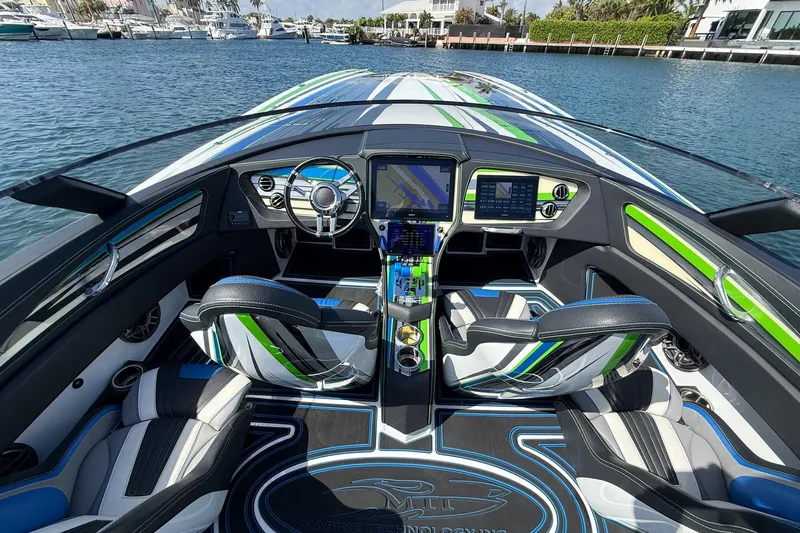  Yacht Photos Pics Interior view of 2022 MTI 390X boat with modern dashboard and seating.