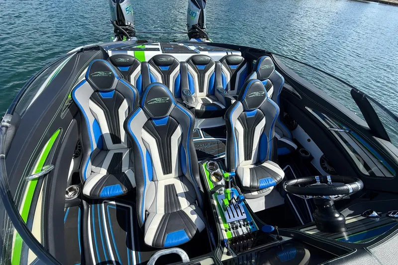  Yacht Photos Pics 2022 MTI 390X boat interior with blue and black racing seats on water.