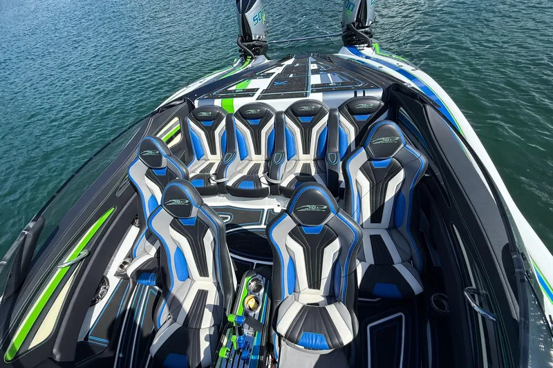  Yacht Photos Pics Luxury MTI 390X 2022 speedboat interior with blue and black seating on water.