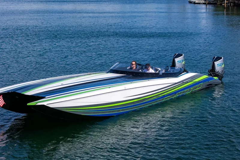  Yacht Photos Pics 2022 MTI 390X powerboat with vibrant stripes on calm water.