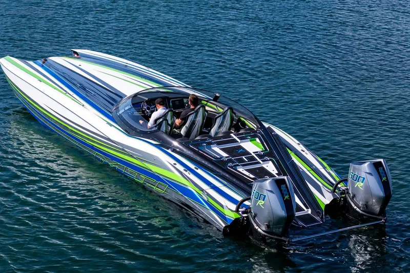  Yacht Photos Pics 2022 MTI 390X speedboat with vibrant stripes, cruising on clear blue water.