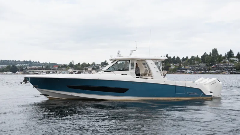  Yacht Photos Pics 2023 Boston Whaler 420 Outrage boat on calm water, side view.