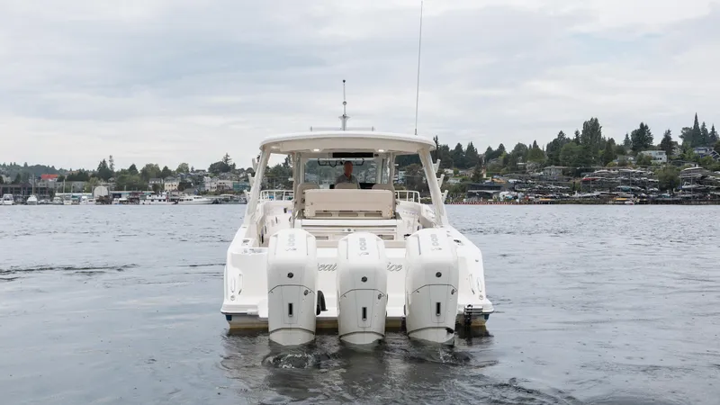  Yacht Photos Pics 2023 Boston Whaler 420 Outrage on water, rear view with triple engines.