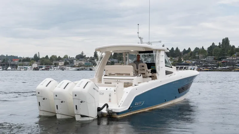  Yacht Photos Pics 2023 Boston Whaler 420 Outrage boat on water, featuring four powerful outboard engines.