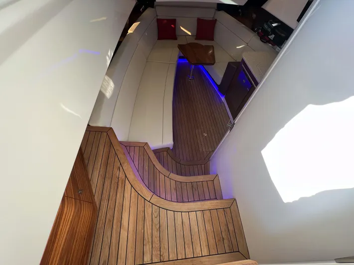  Yacht Photos Pics Luxurious interior of 2023 Boston Whaler 420 Outrage with elegant wood flooring and ambient lighting.