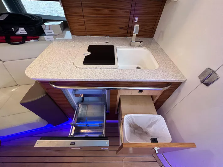  Yacht Photos Pics 2023 Boston Whaler 420 Outrage kitchen area with sink, storage, and modern design.