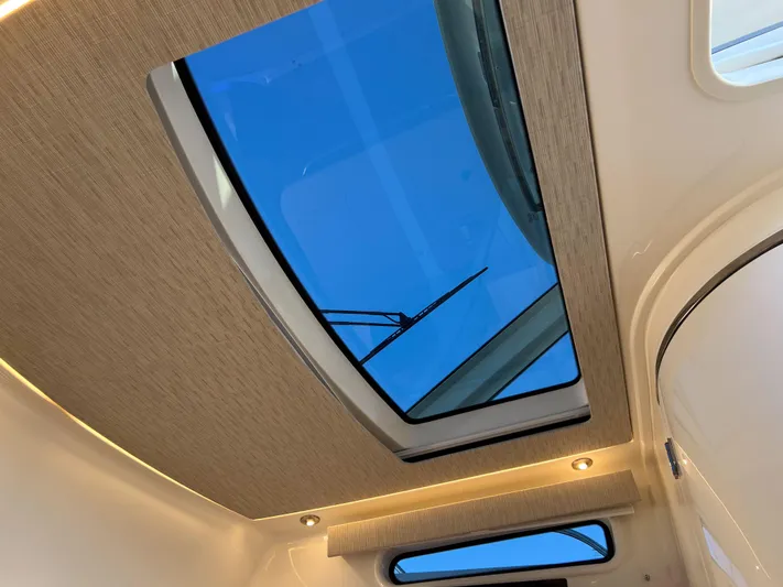  Yacht Photos Pics 2023 Boston Whaler 420 Outrage cabin skylight with modern interior design.